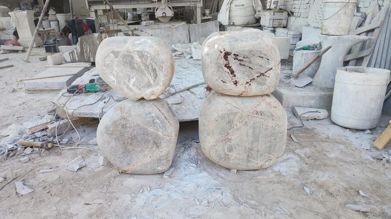 Four console support volumes during rough shaping in the Jaipur workshop